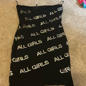 black dress that has silver letters saying all girls. never worn before